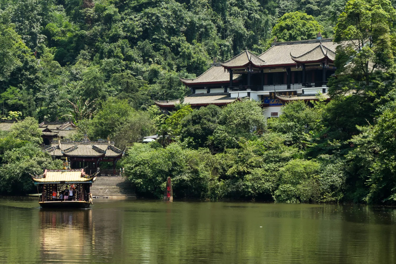 Yuecheng Lake at Qingcheng Mountain with forested slopes around it